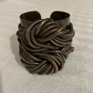 Dannijo cuff bracelet in bronze tone metal.
